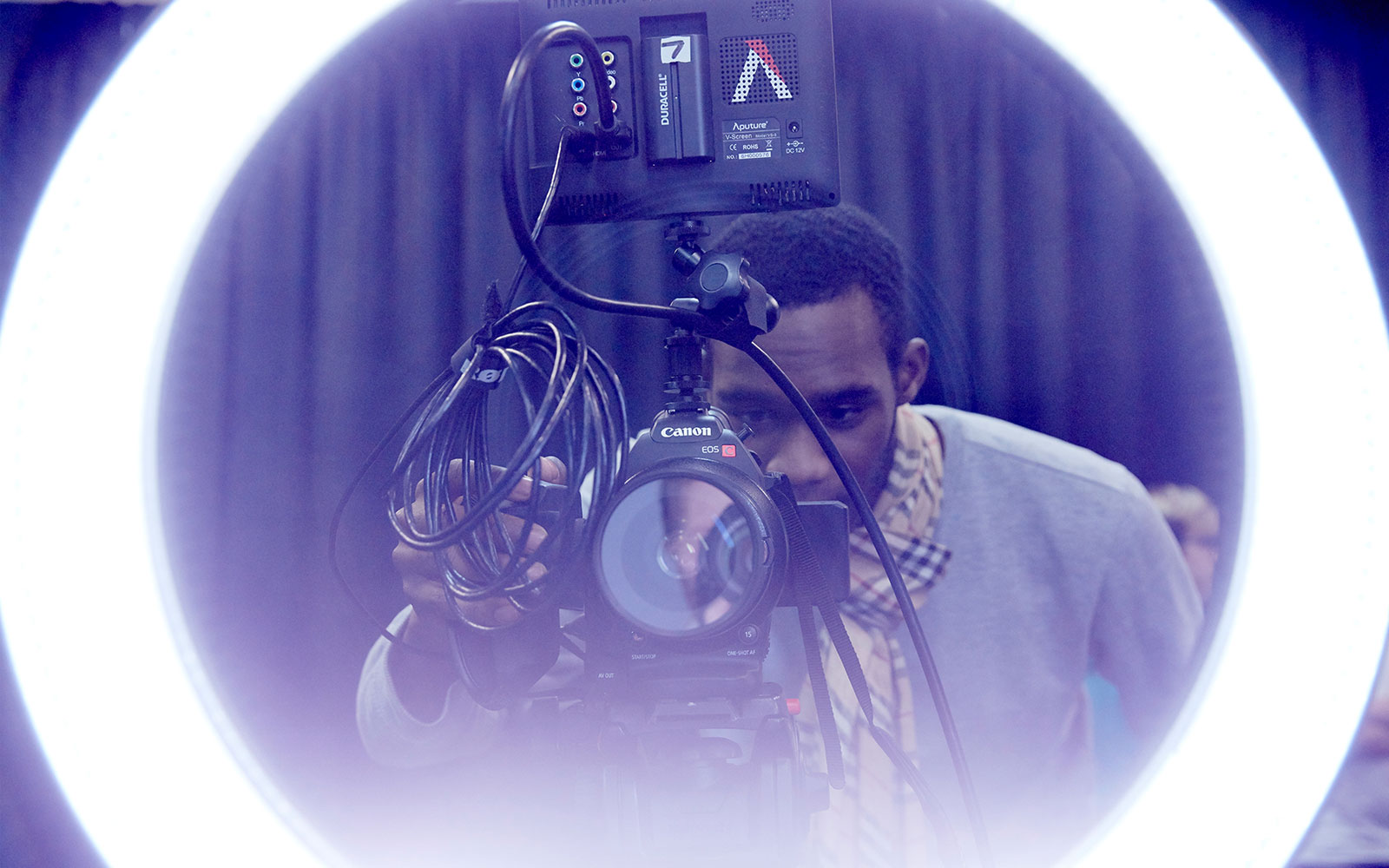 Student behind camera