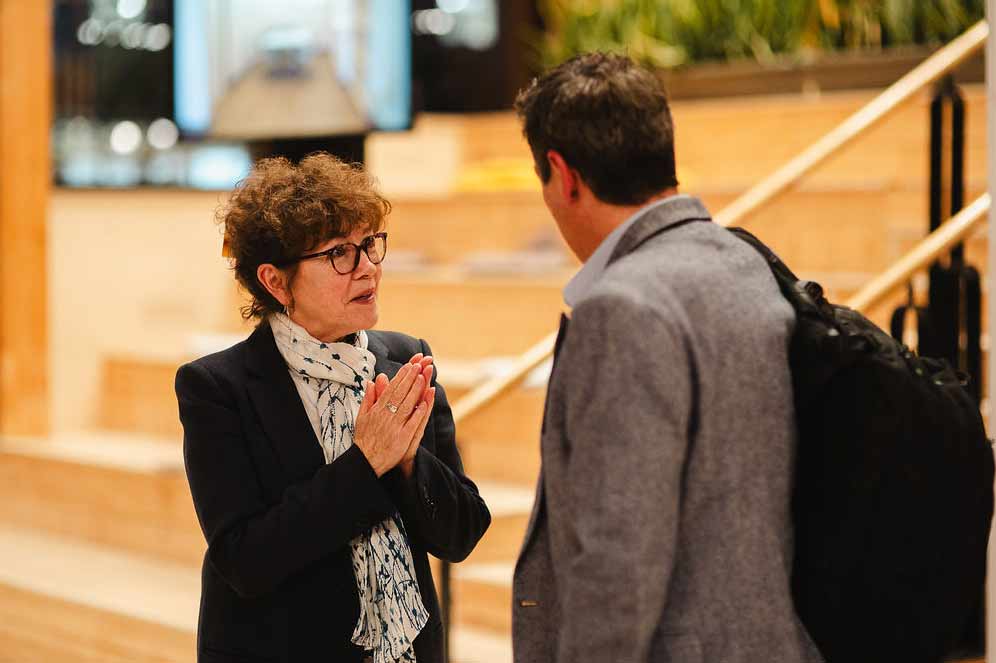Staff members talking at a Communities Centre event.