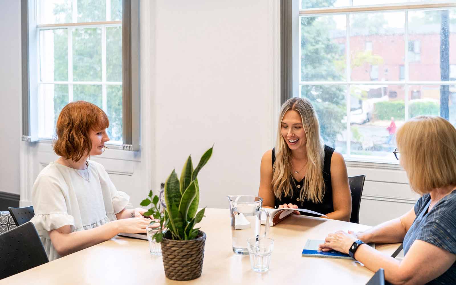 Three people talk together in a Communities Centre session.