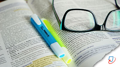 book, highlighters and glasses