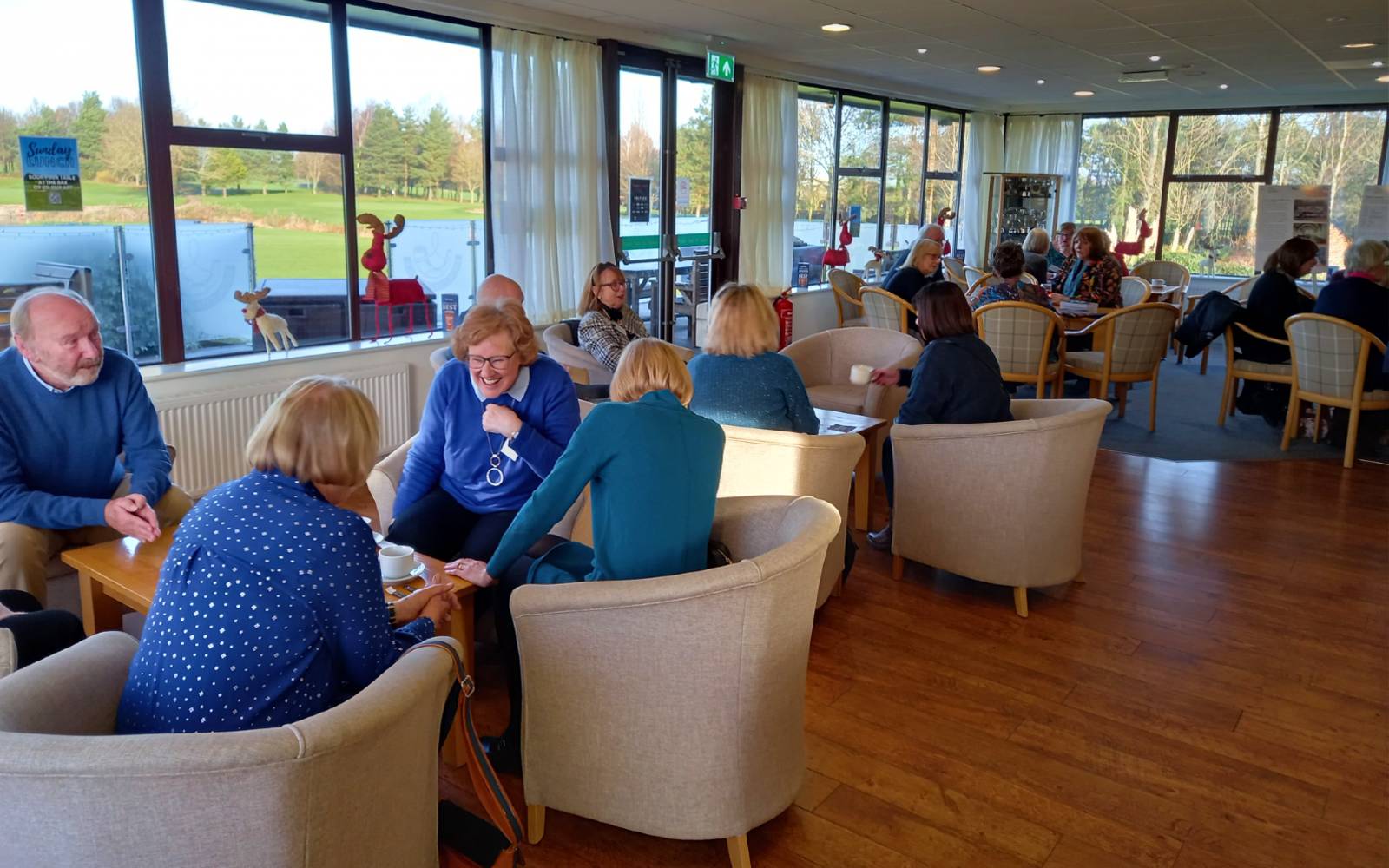 People sitting around tables talking and laughing