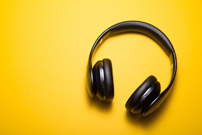 Black music headphones with yellow background