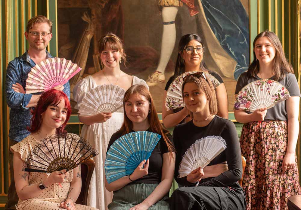 English Literature lecturer and students at a Georgian fan workshop