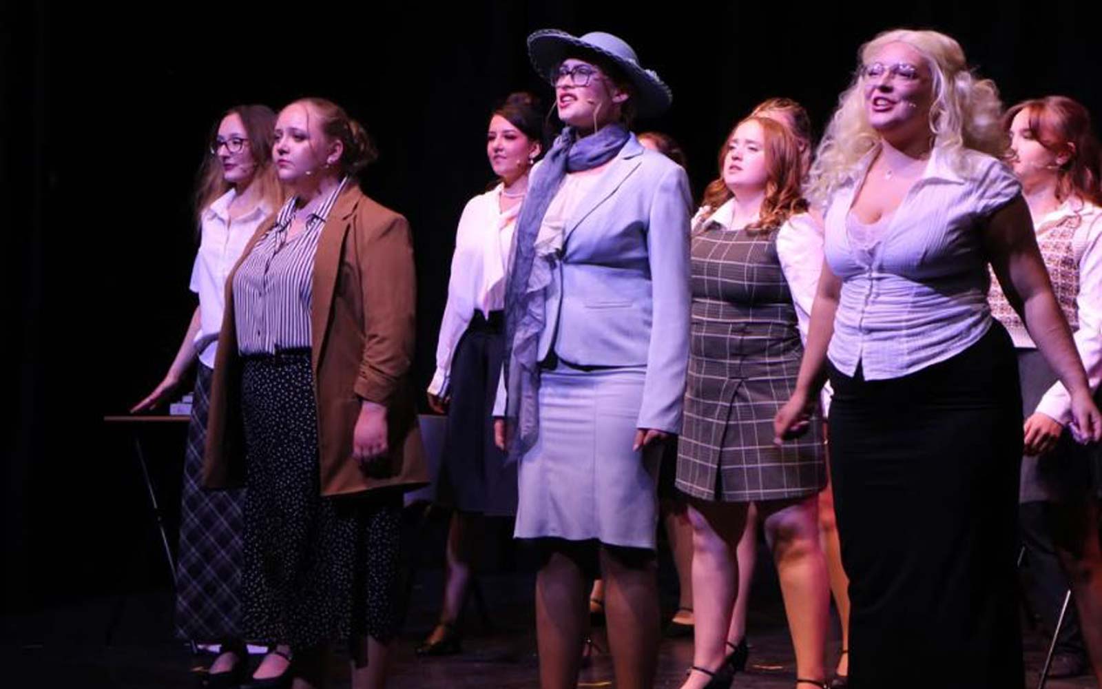 The cast of a production of 9 to 5: The Musical.