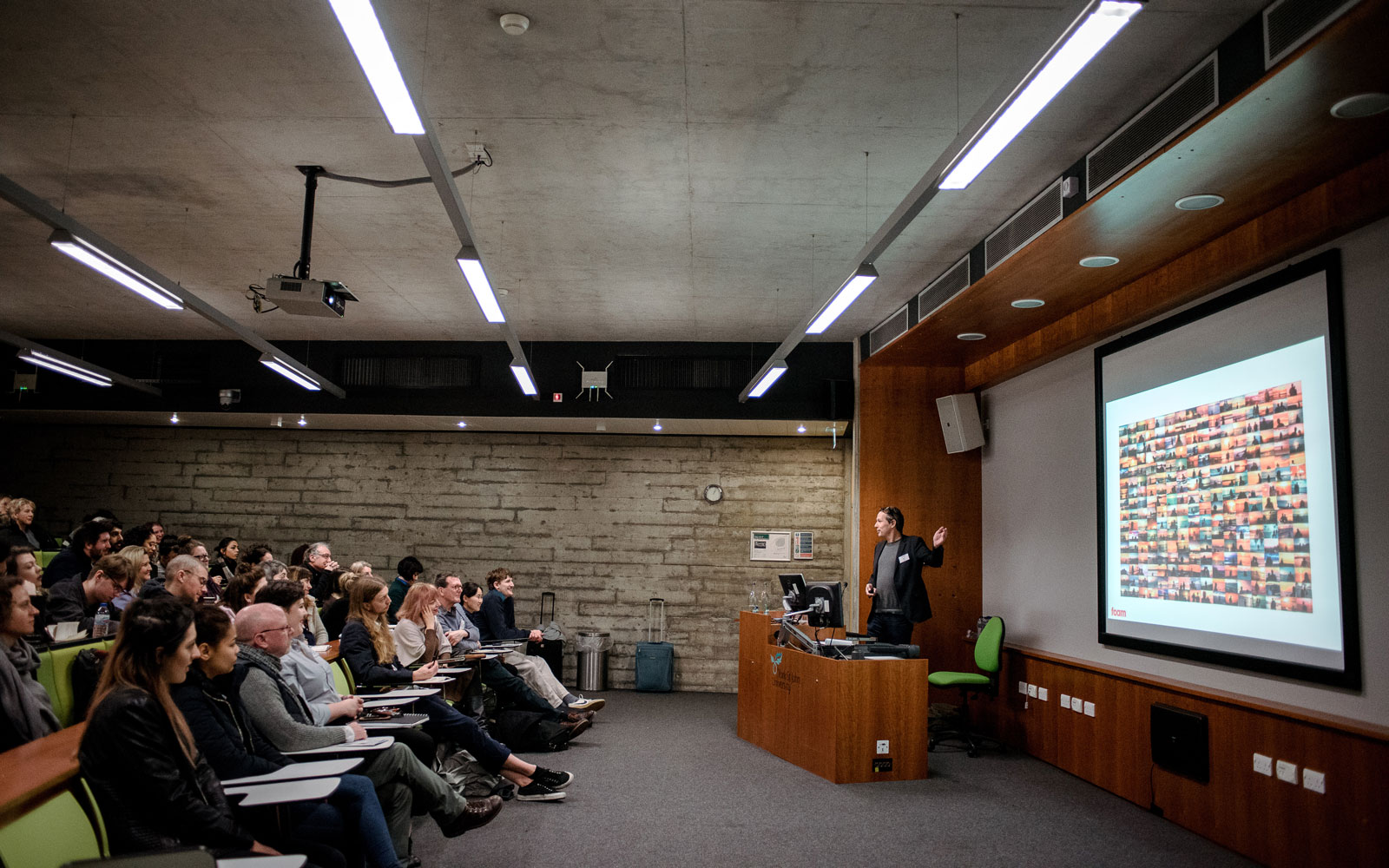 Students taking part in a course talk with a lecturer