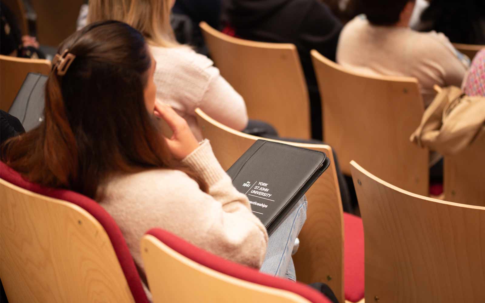 Student with degree apprenticeship booklet