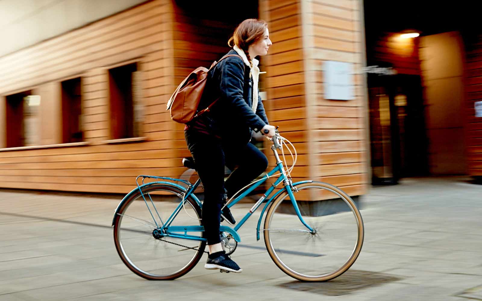 A student riding a bike on campus.