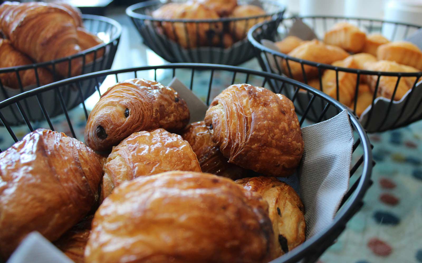 Baskets of breakfast pastries on a table