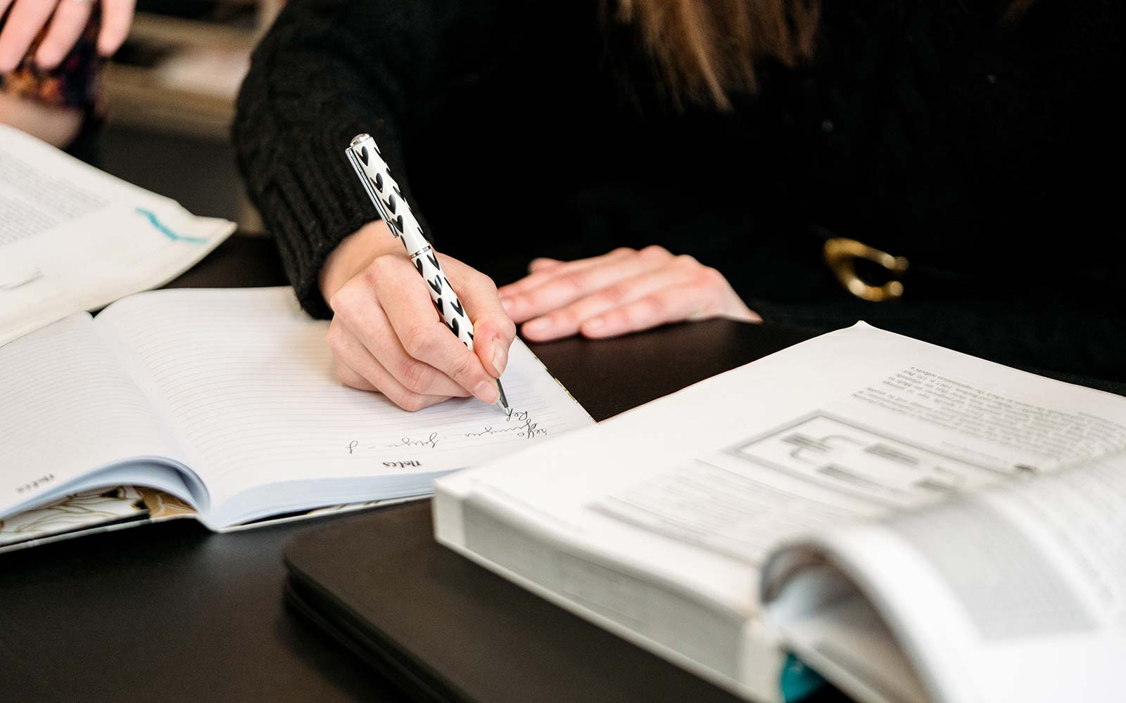 Student writing in a notebook