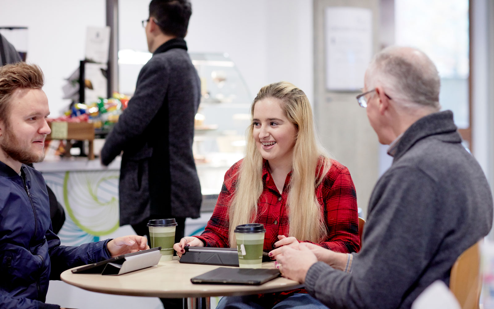 Group having a chat and a coffee talking about business
