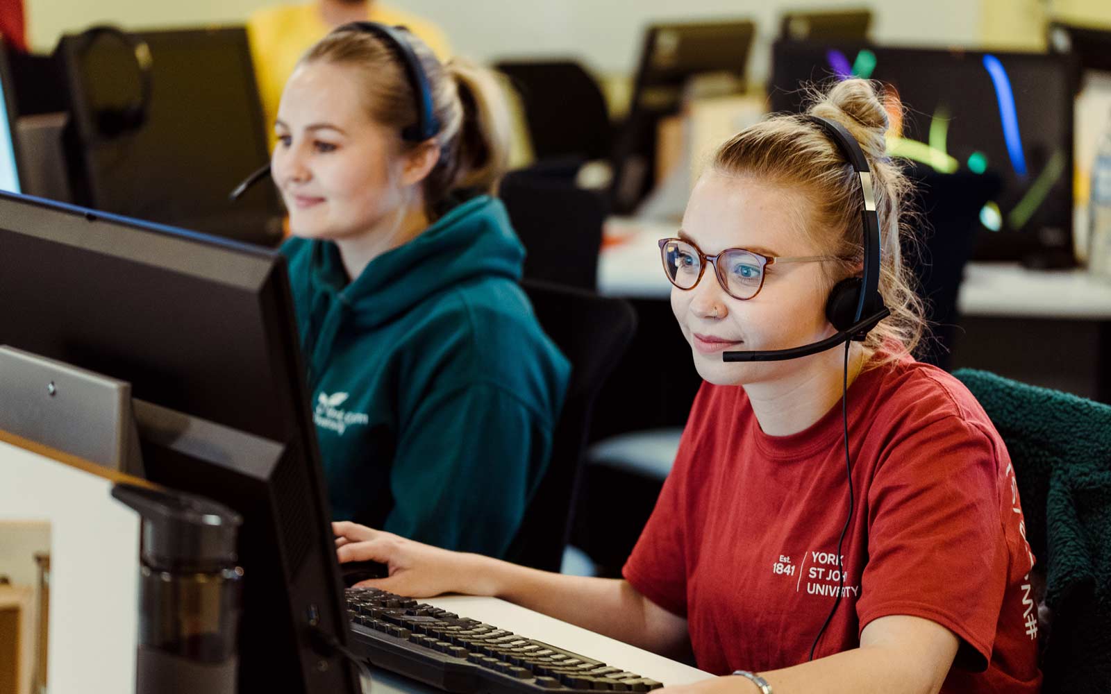 Student helping take calls from applicants