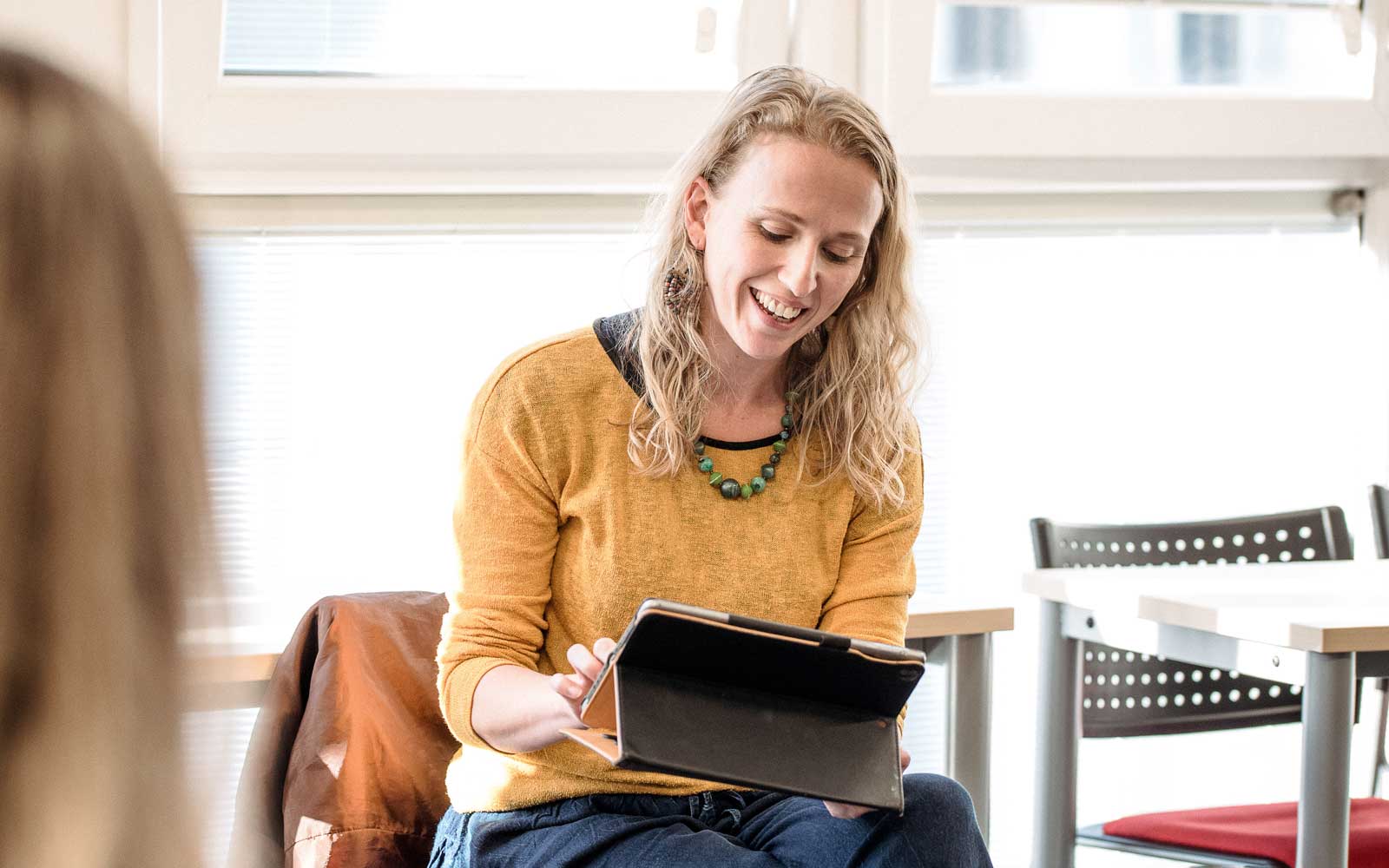 Student looking at ipad in discussion group
