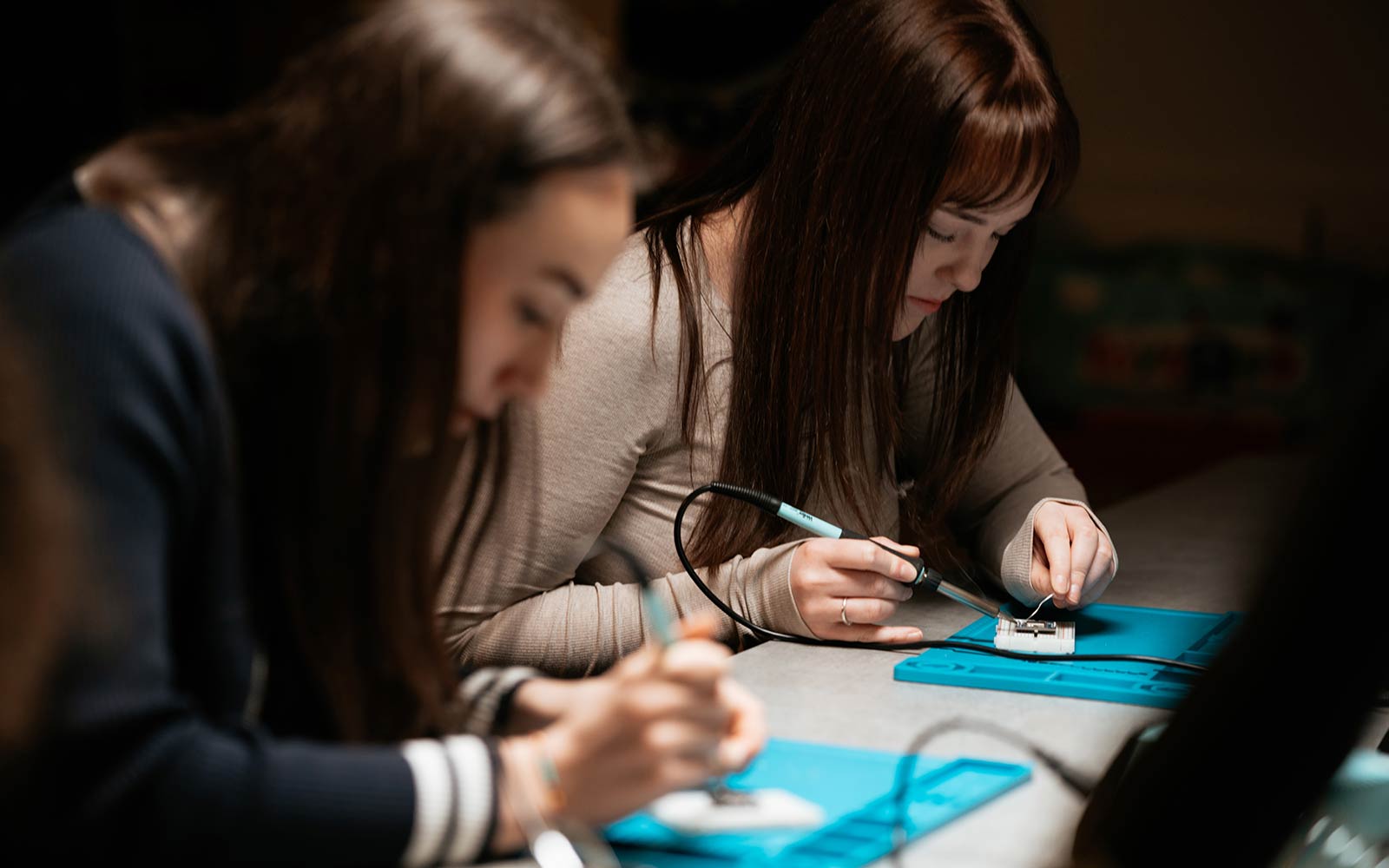 Two computer science students at work
