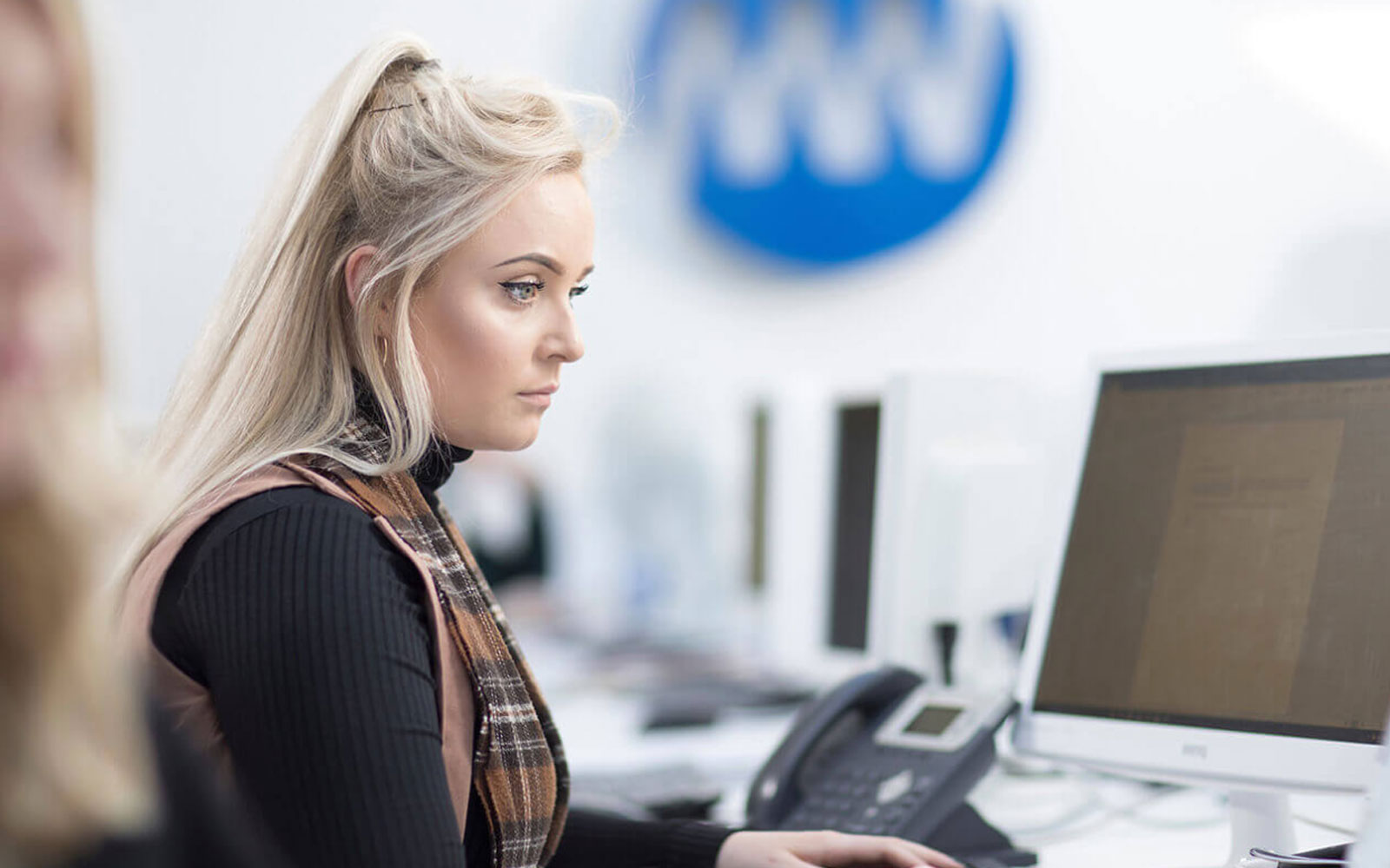 Girl working at a computer in the Media Works offices