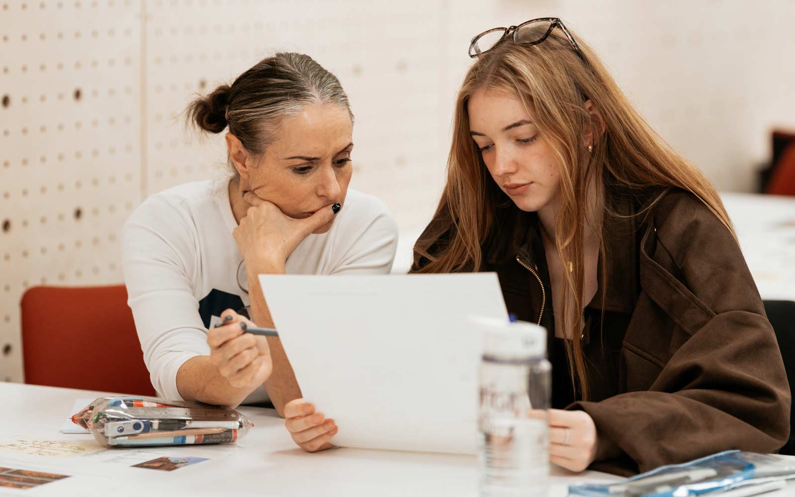 A tutor and student looking over some work together.