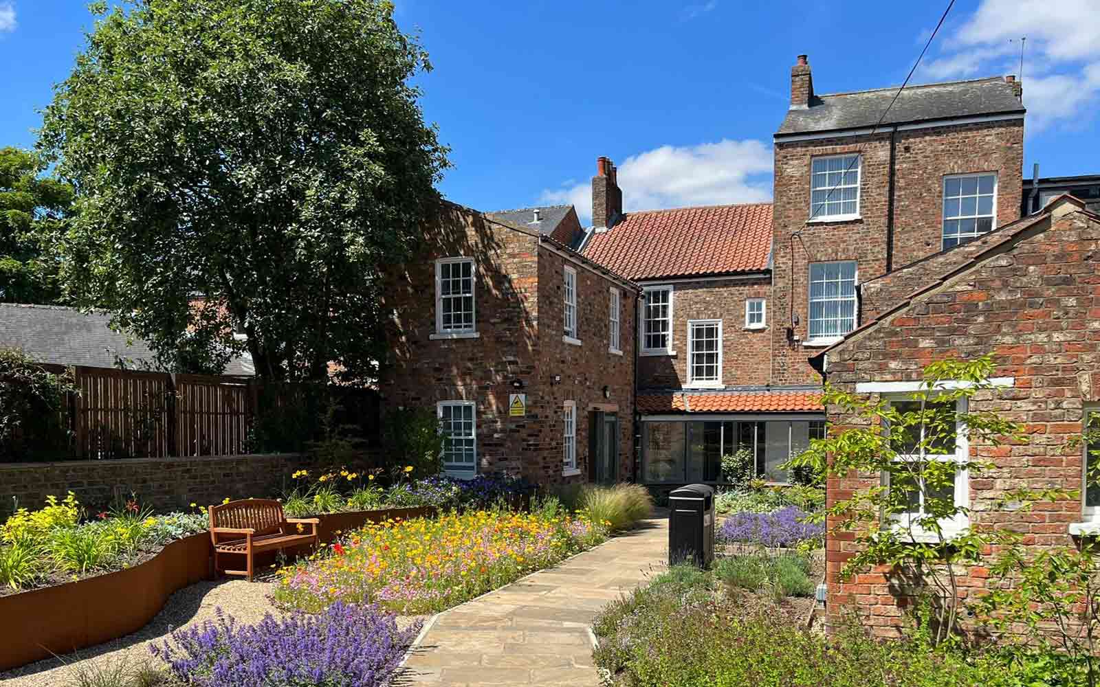 Exterior of the York St John University Communities Centre on a sunny day.