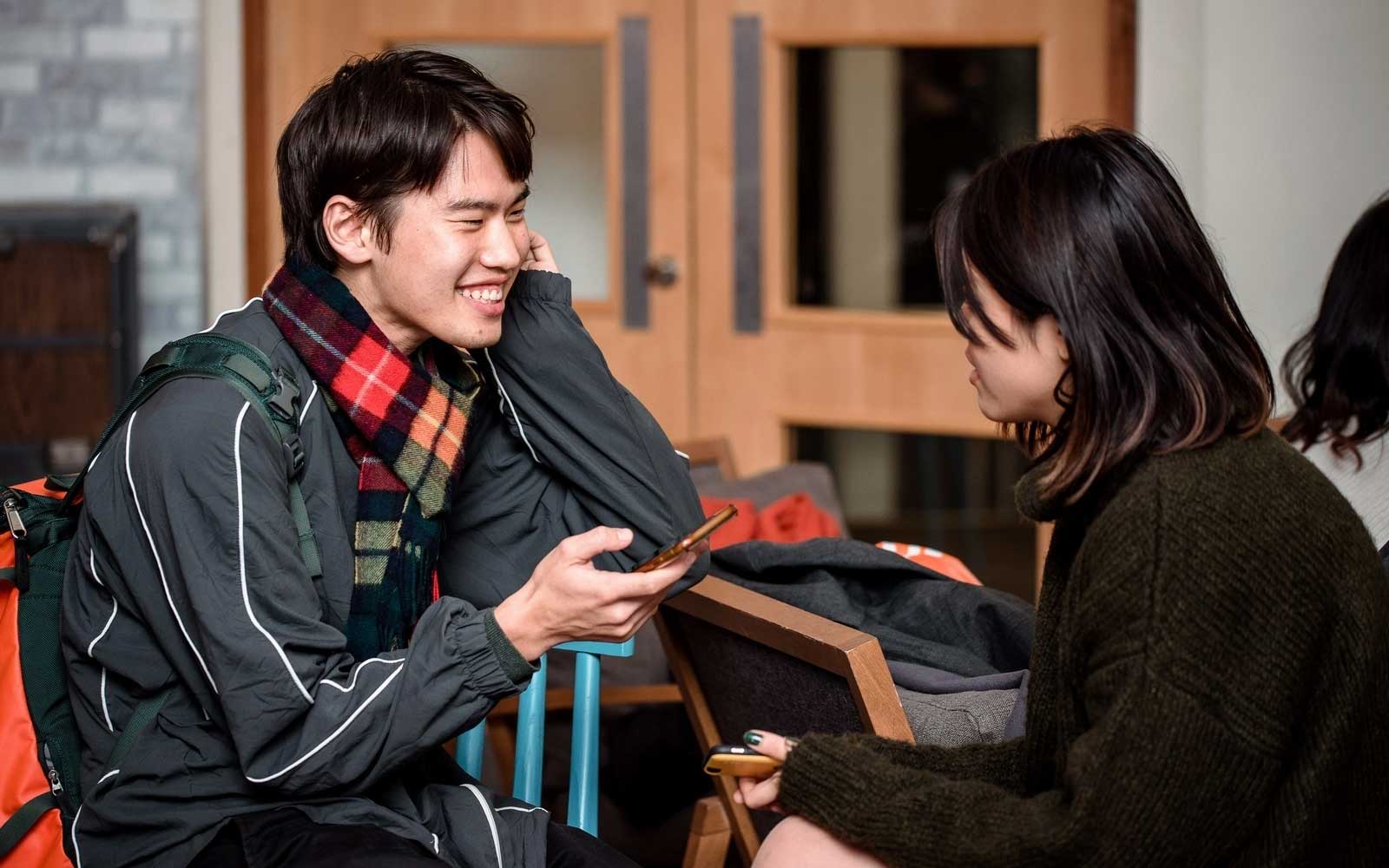 Two students chat at a Global Cafe event.