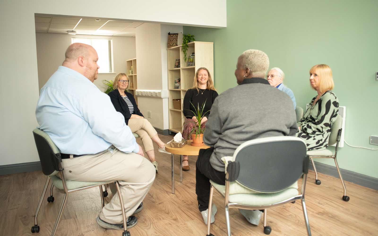 A group of people sitting in a circle during a Communities Centre session.