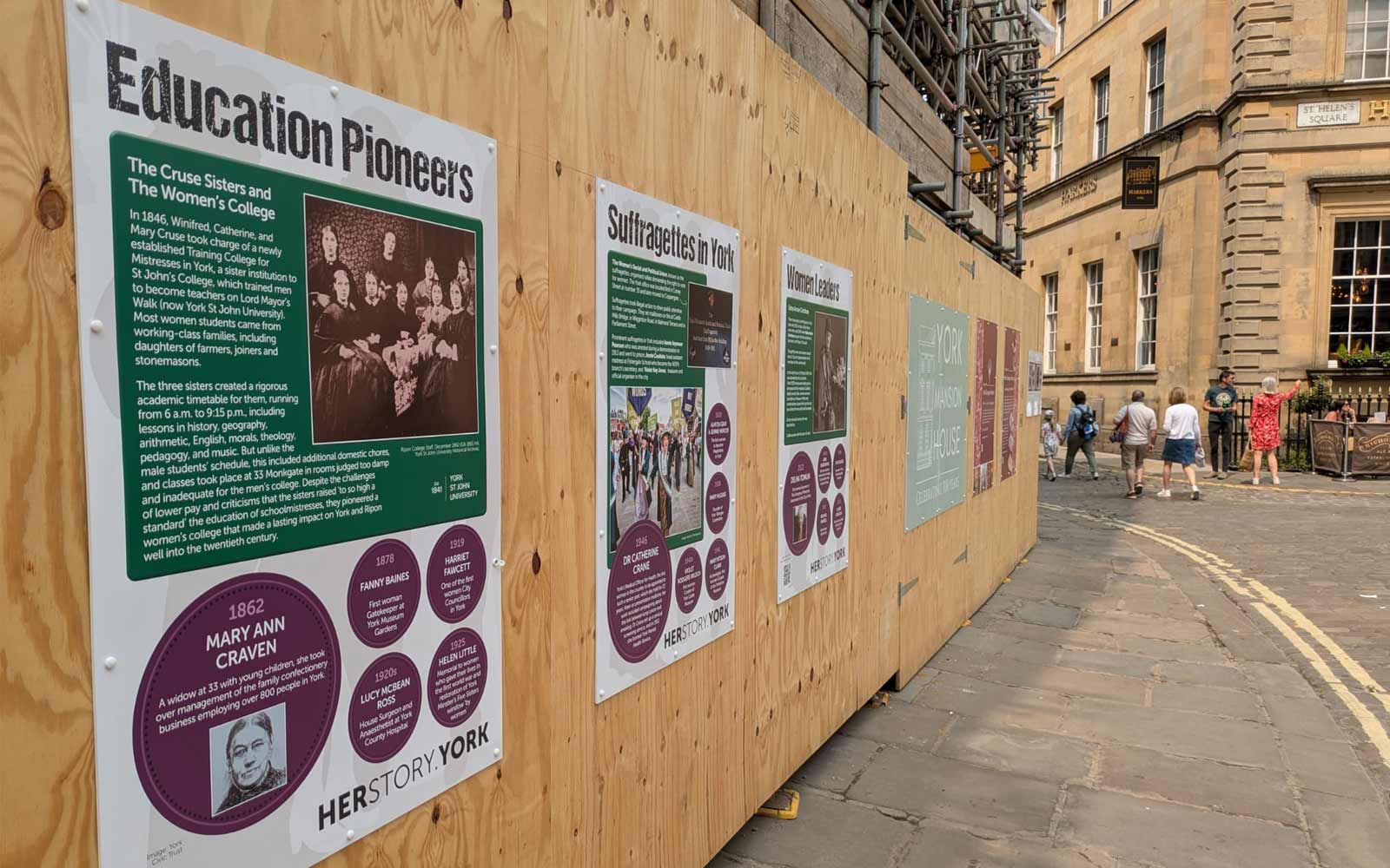 Hoardings outside the Mansion House in York city centre, with Women's Herstory boards featuring historical female figures.