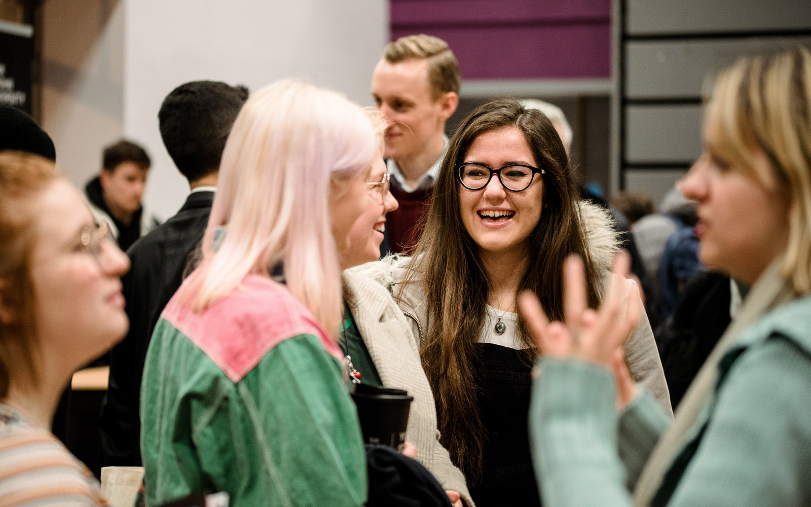 A group of students talking at an open evening