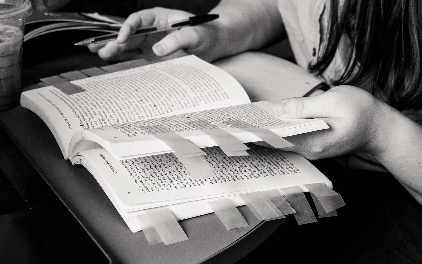 Close up of book with pages marked with post-it notes