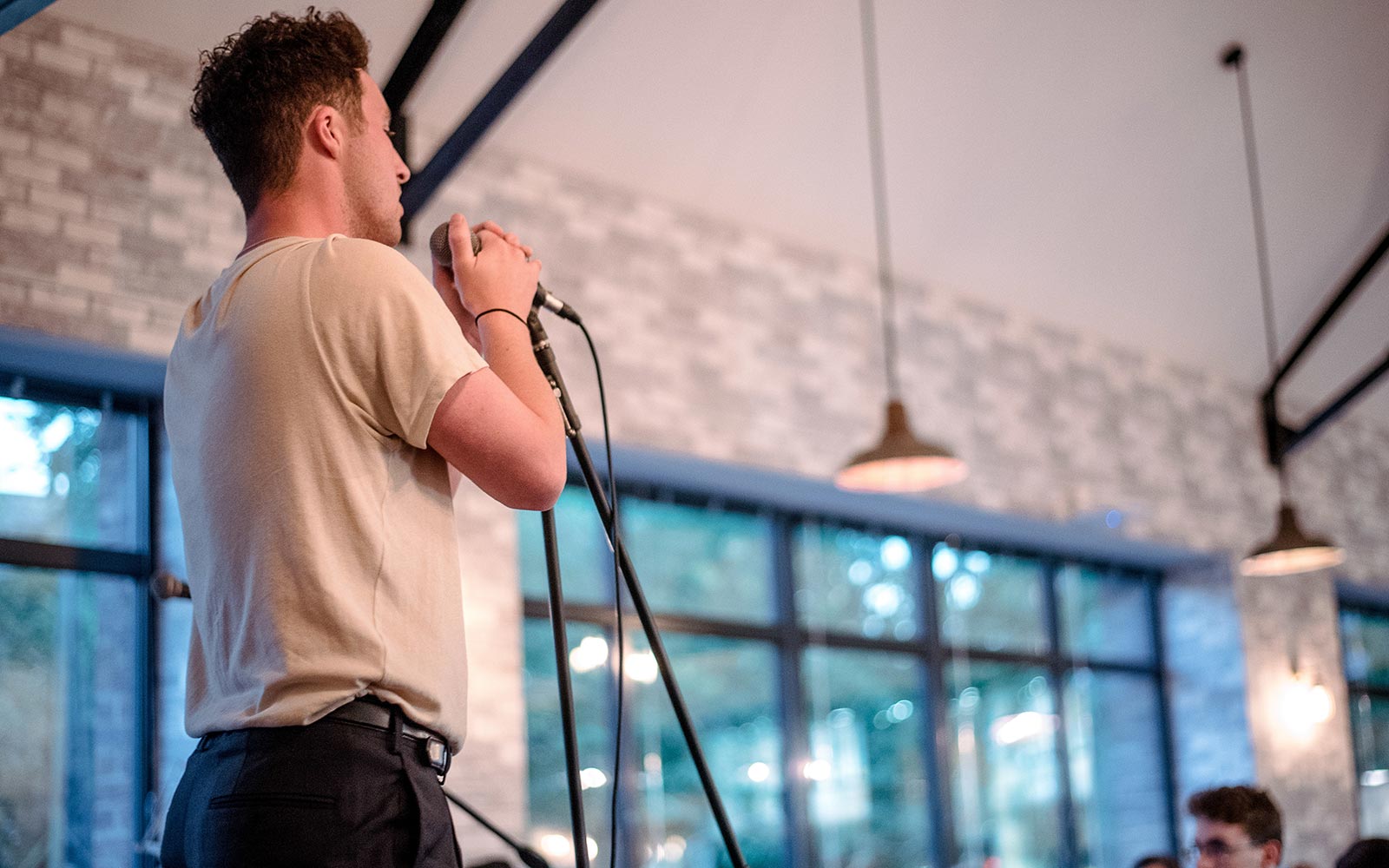 Student singing into microphone in the Students' Union