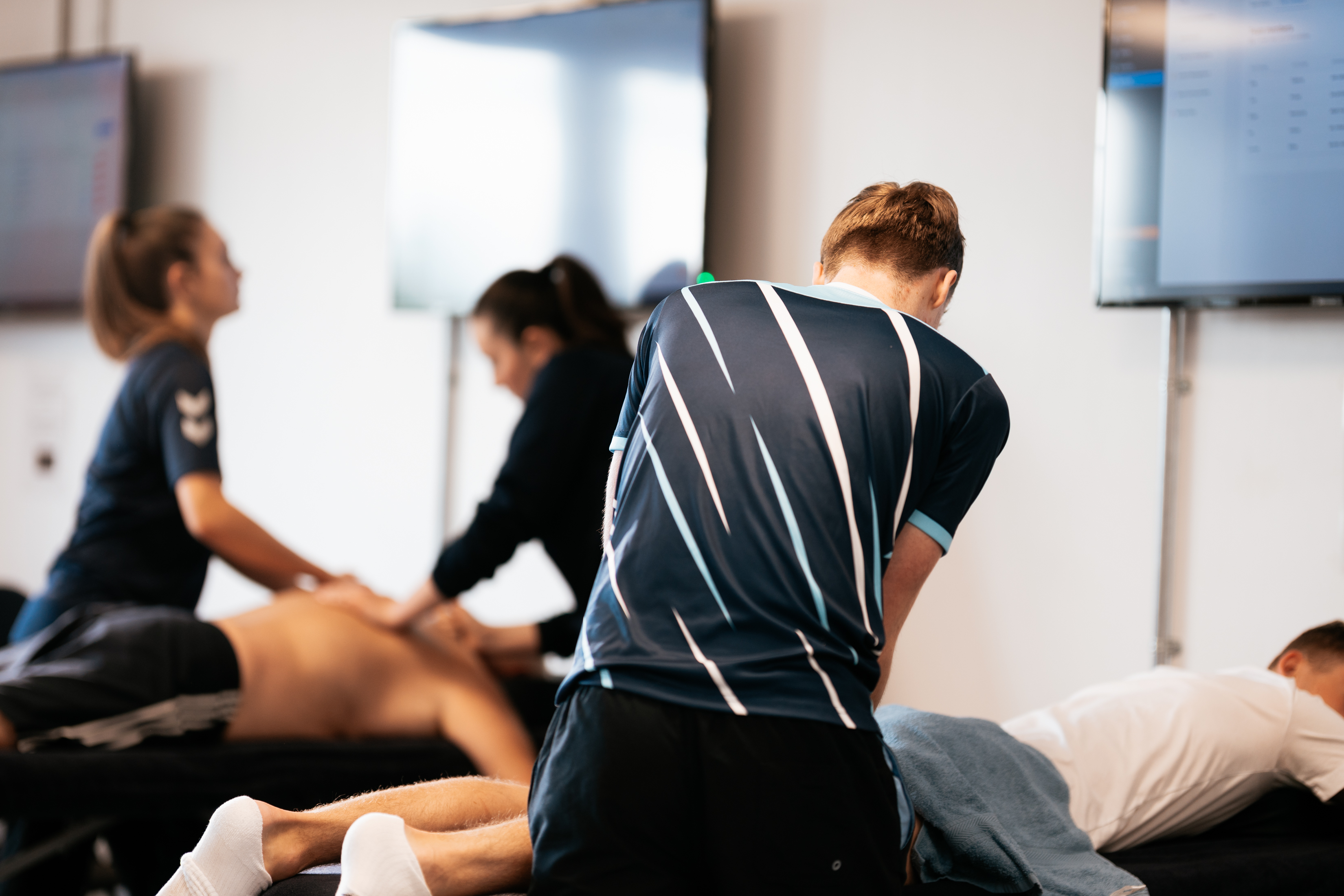 Sports students giving therapy