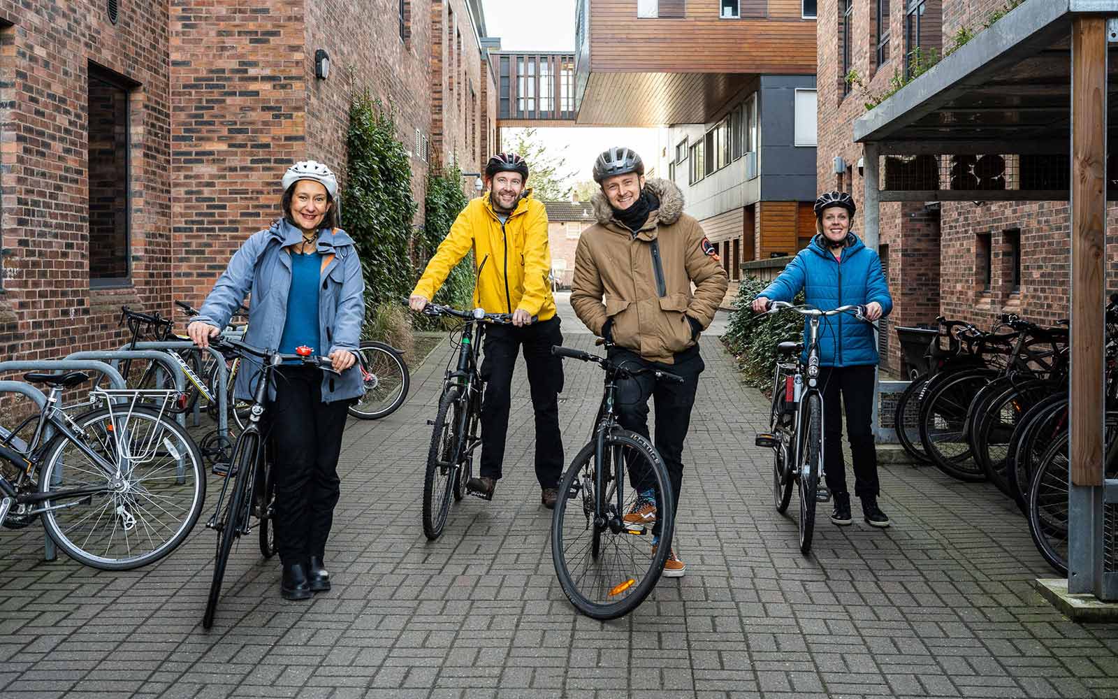 Staff members with their bicycles on campus.
