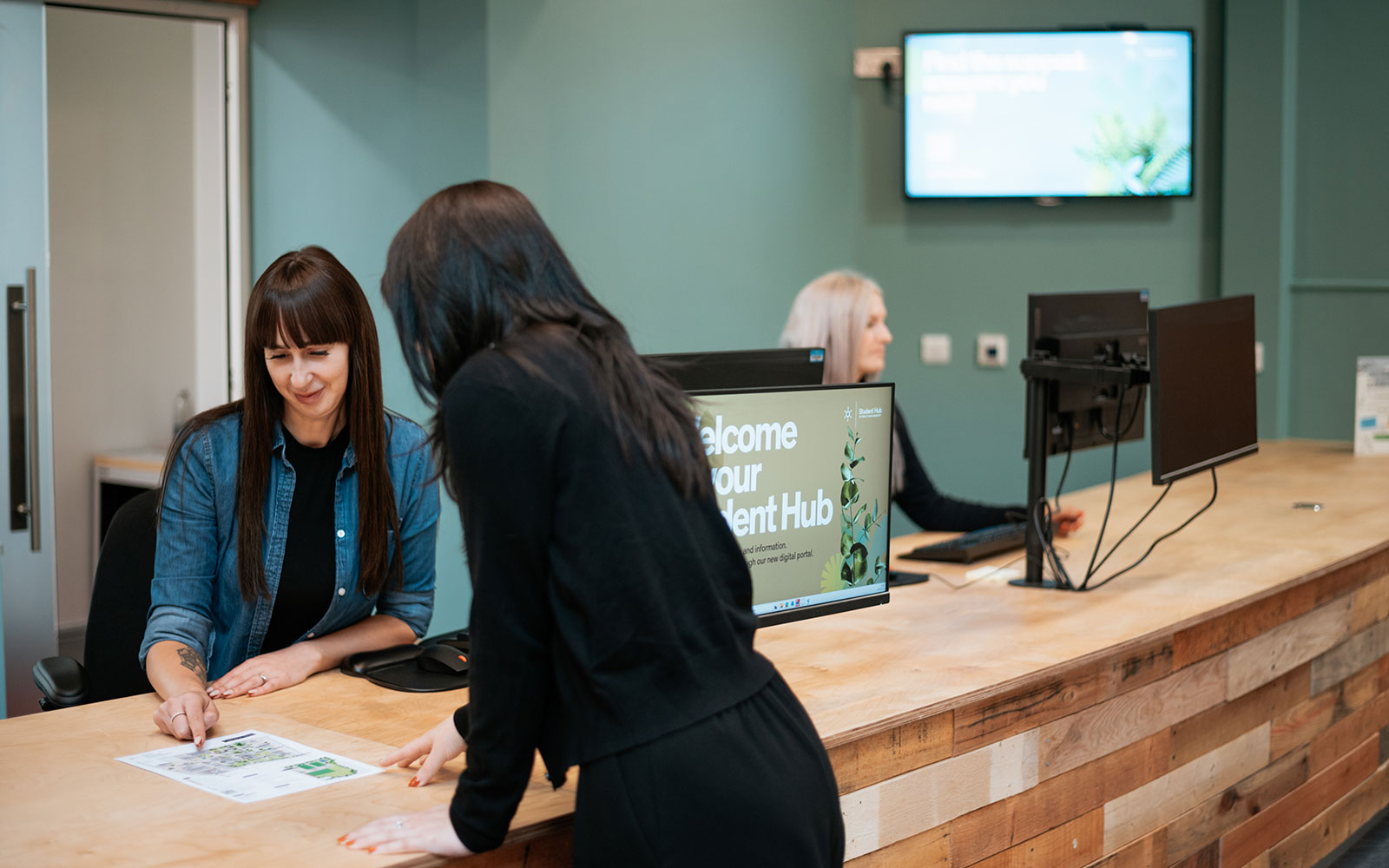 Student asking for help at Student Hub desk on York Campus