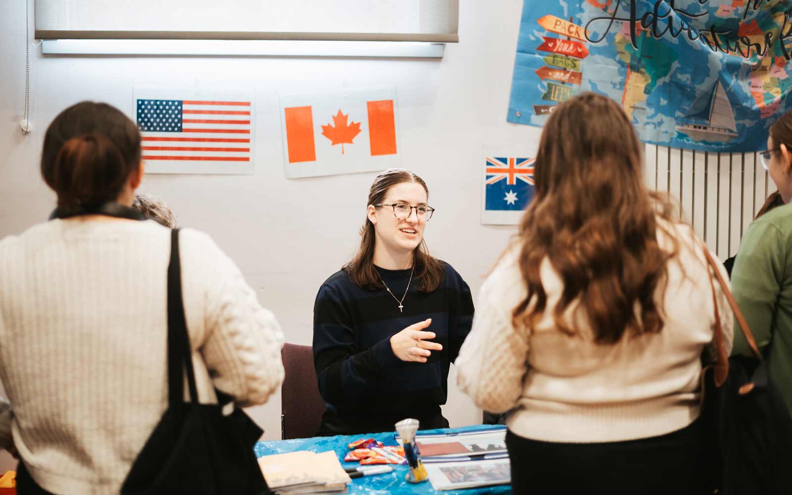 A study abroad staff member talking to students.