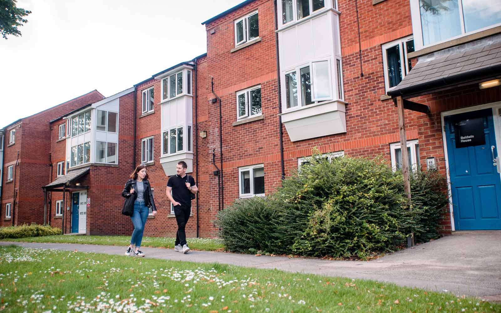 Two students walk outside the Grange accommodation site.