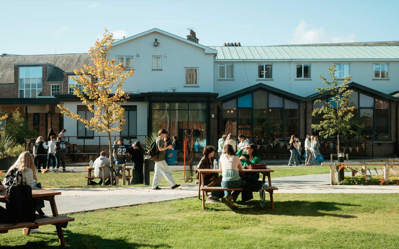 Students sitting and chatting outside on campus.