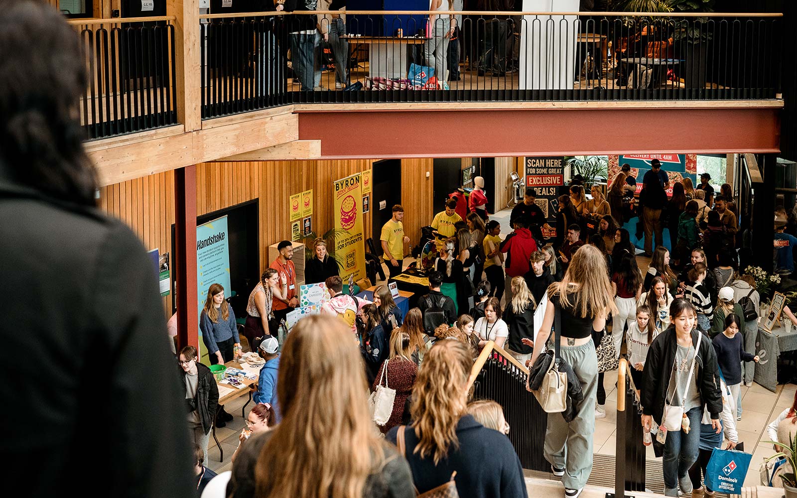 Students in Creative Centre atrium, exploring stalls