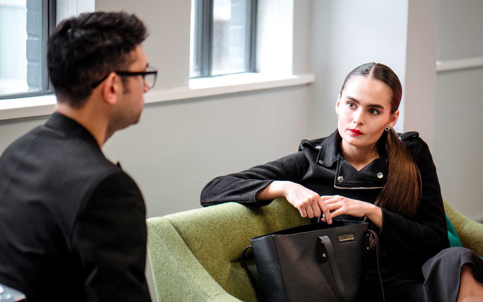 Student and staff member sat in chairs talking