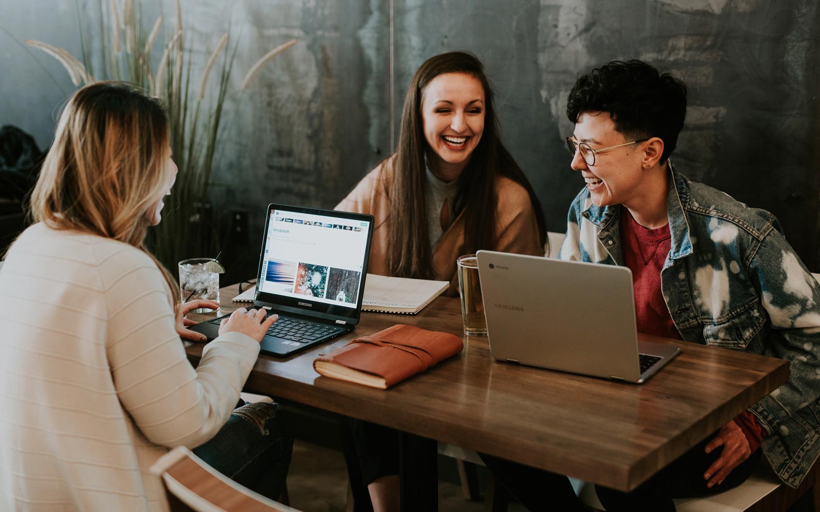 A group of young people smiling and working together