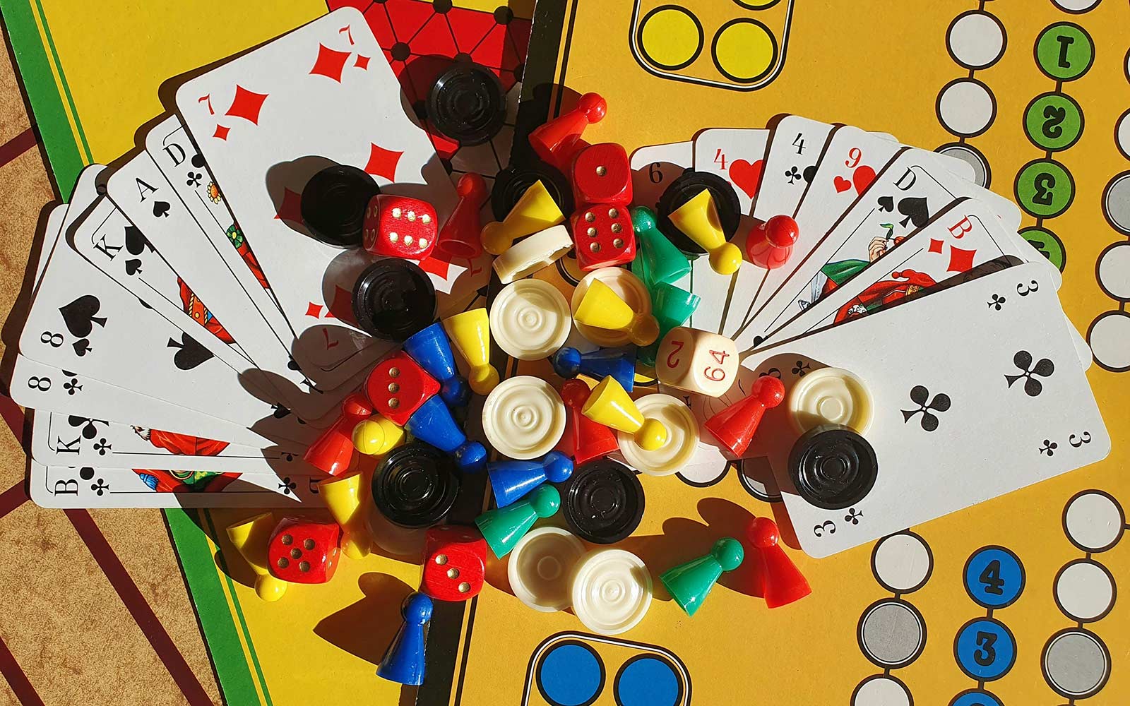 Pieces from different board games including drafts and ludo.