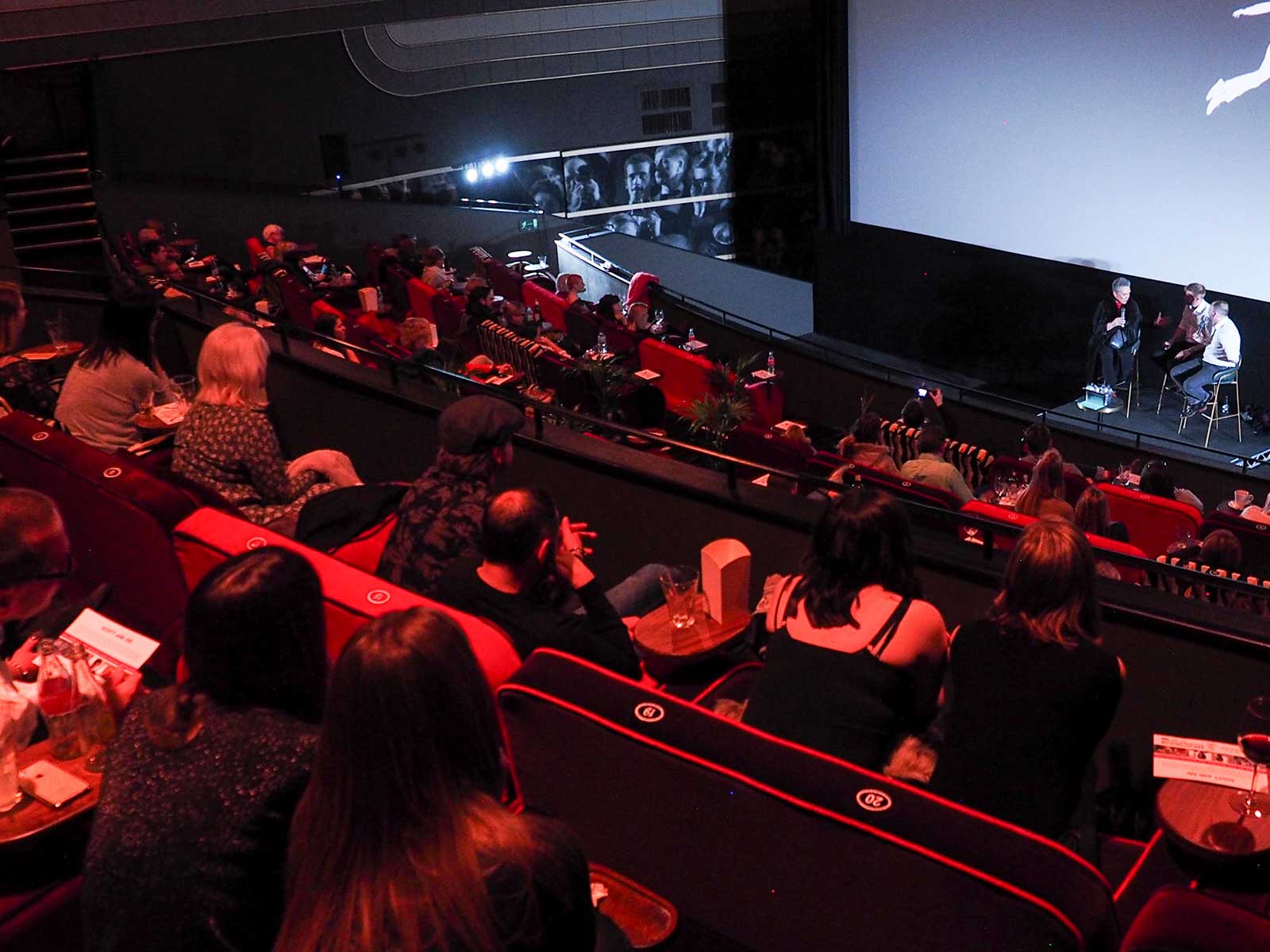 High angle shot of of people in a cinema listening to a speaker