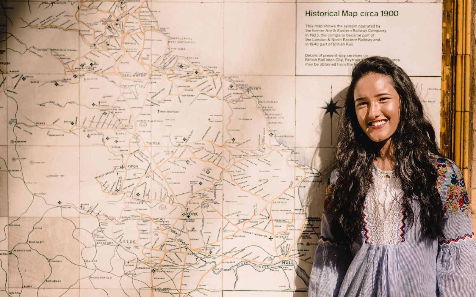 Student stood in front of map of Yorkshire