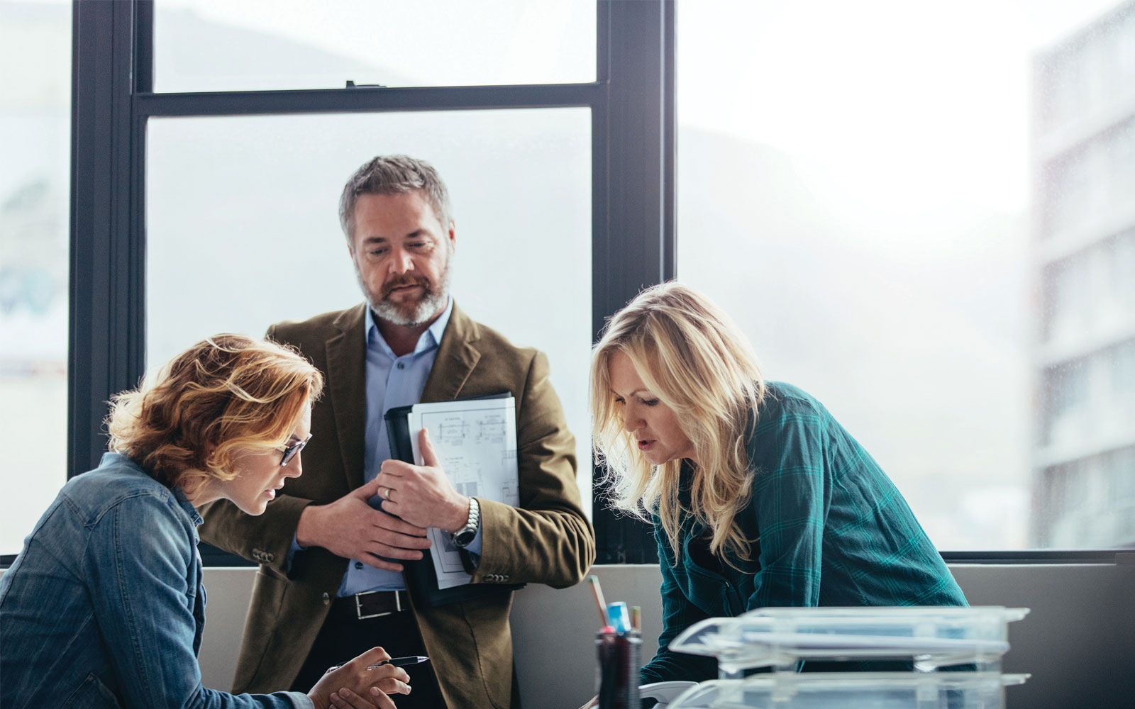 three people working on a project together