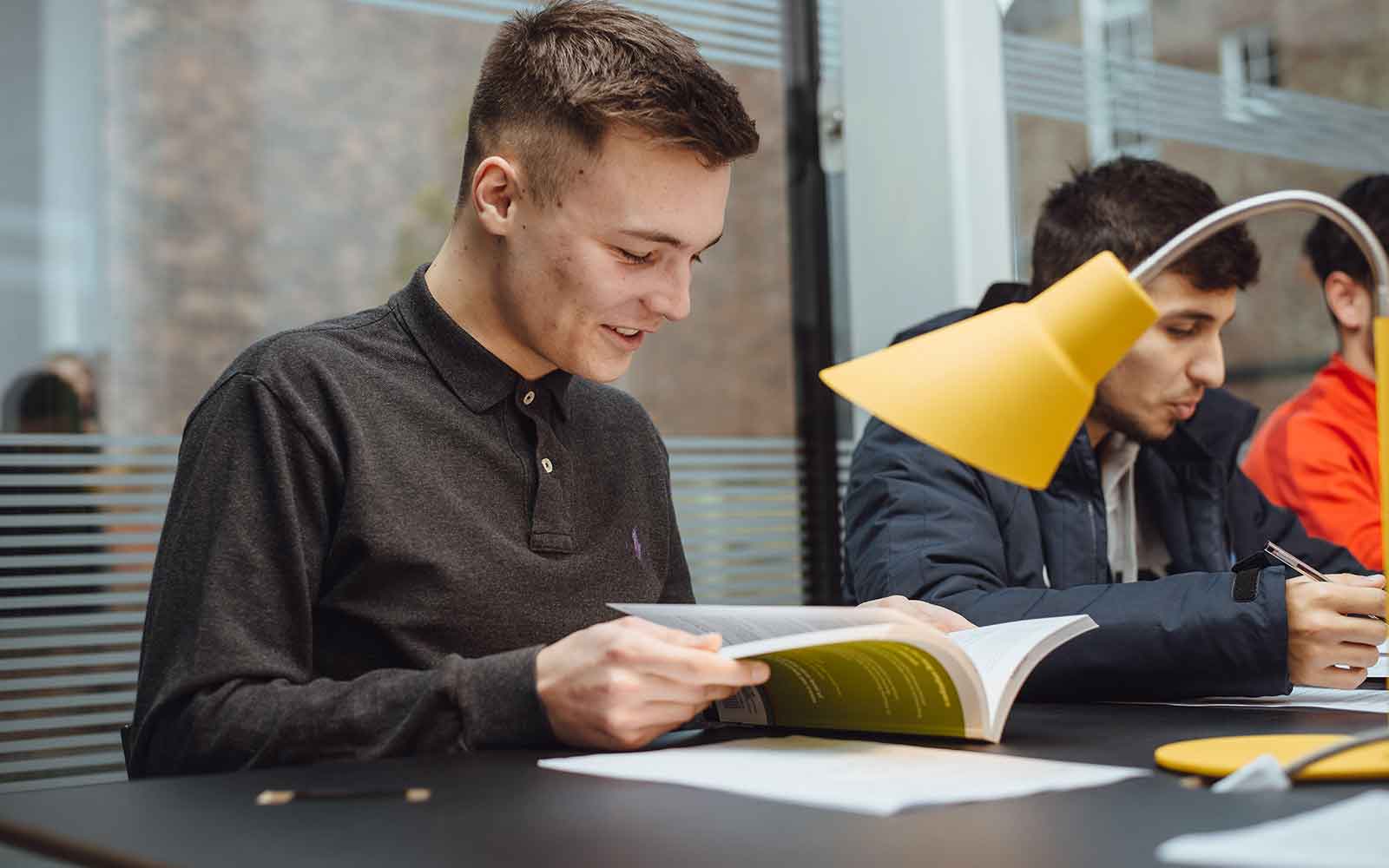 Student reading a book in launchpad