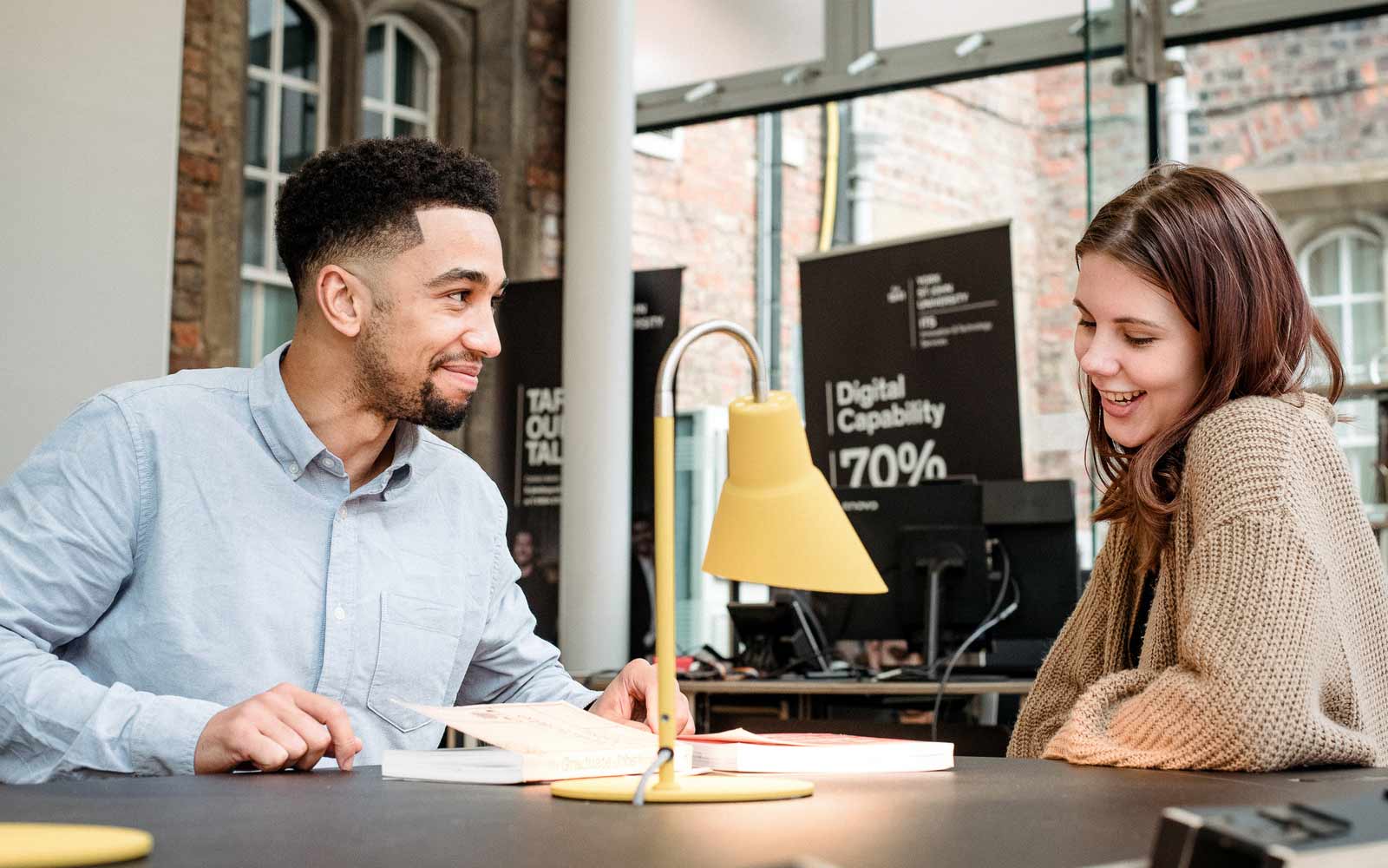 A member of staff talks to a student in the careers centre.