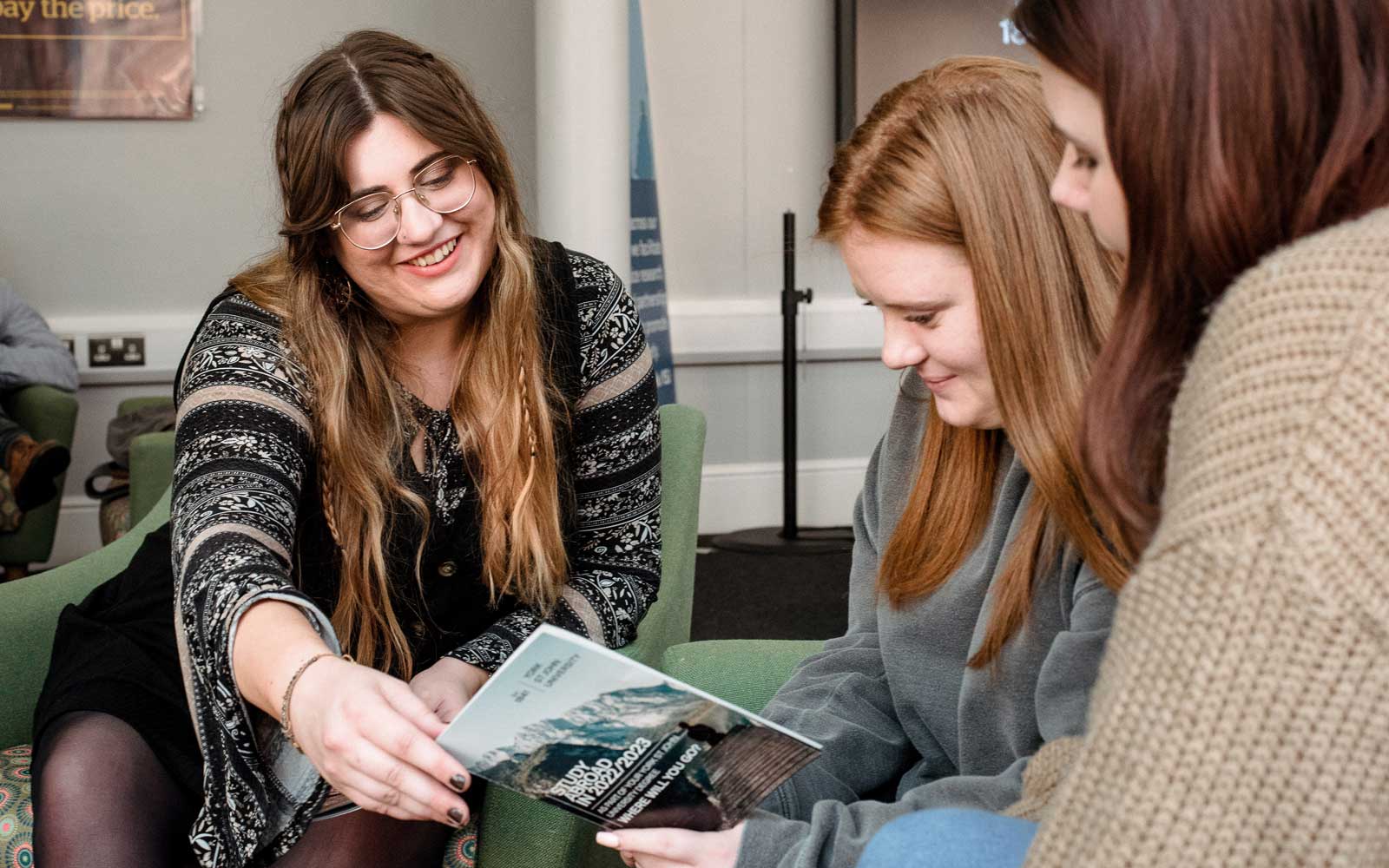 Students in LaunchPad looking at booklet about Study Abroad