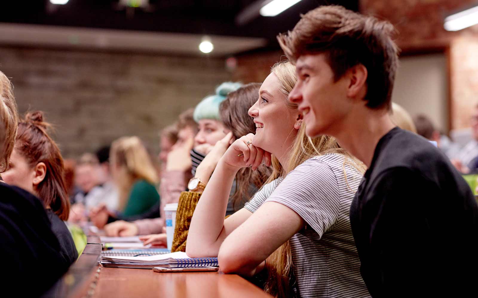 Students sitting in a lecture theatre.