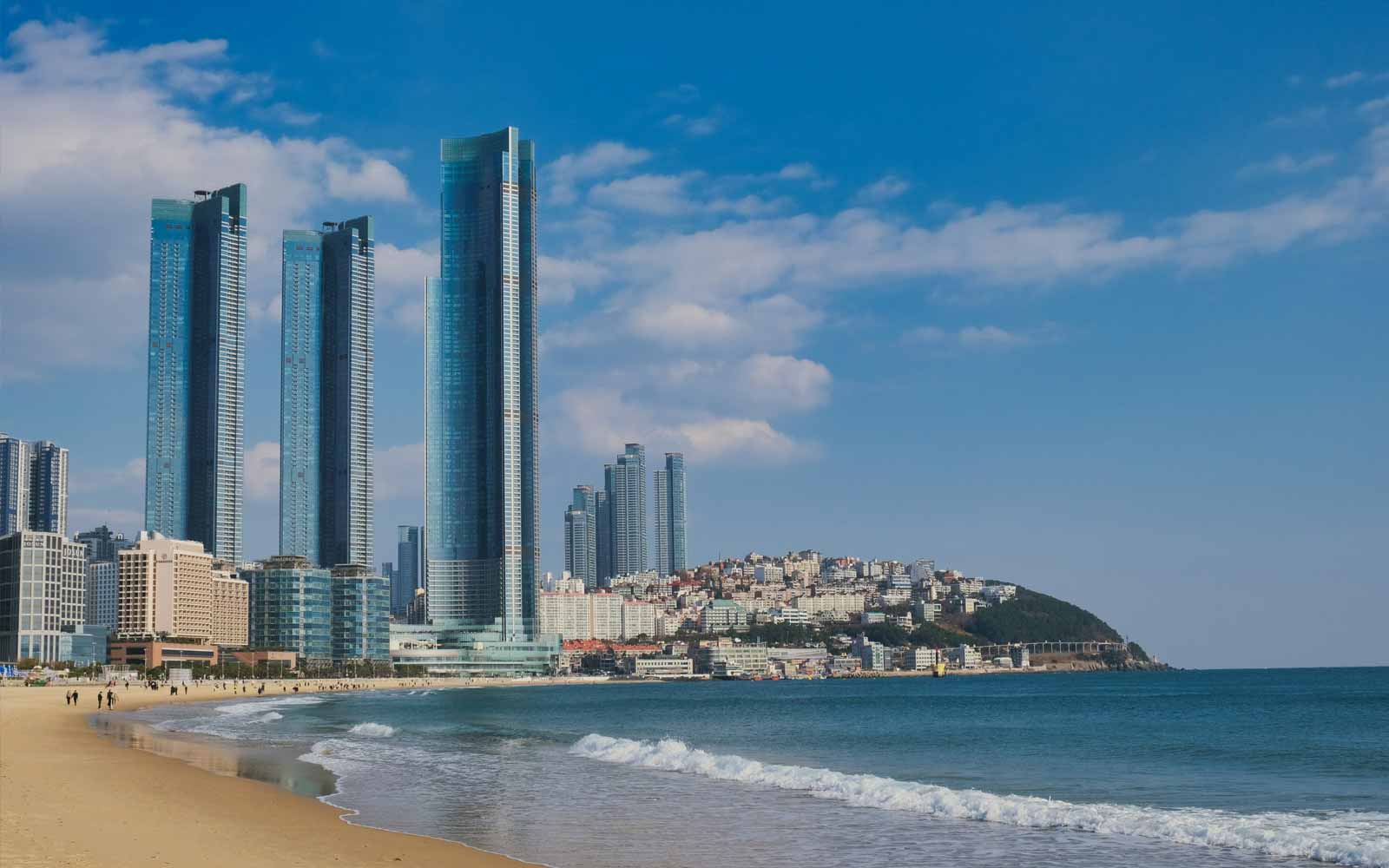 Skyscrapers overlooking Haeundae Beach in Busan, South Korea. Photo by Minku Kang on Unsplash.