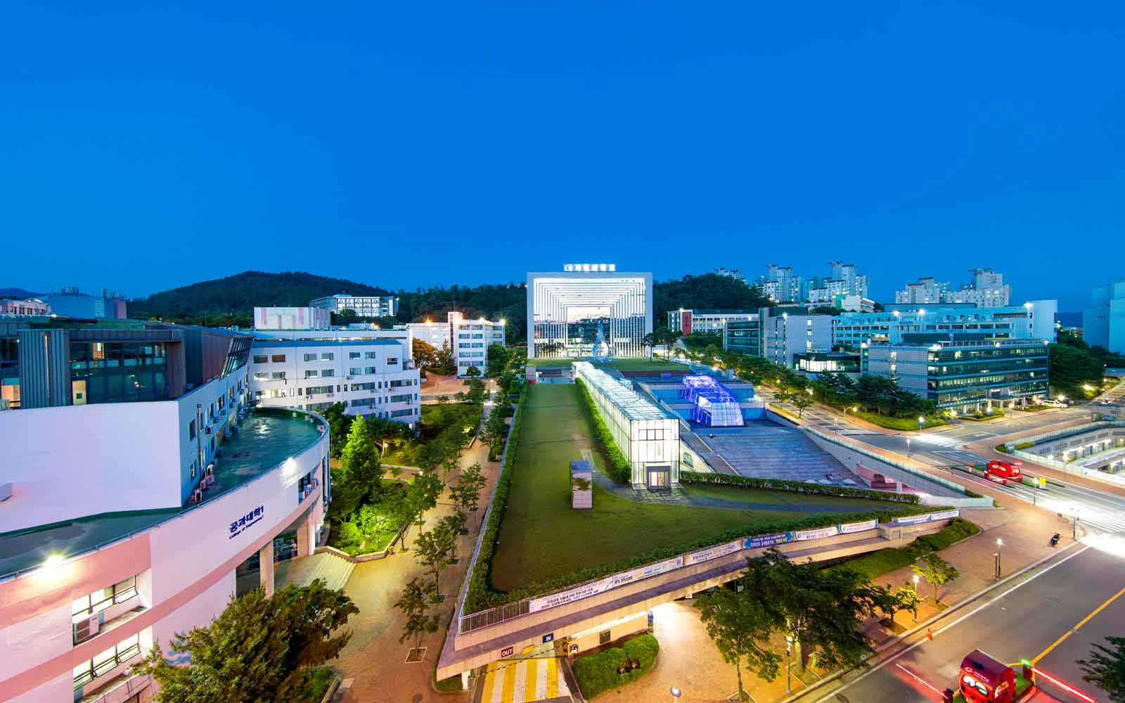 Modern mirrored building overlooking lawns on Gachon University campus.