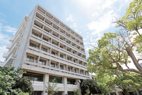 Modern building with trees on Kobe University campus.