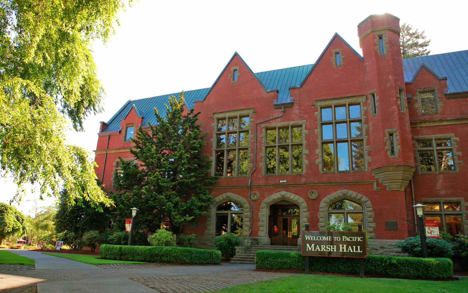 Pacific University Marsh Hall campus building, with trees in foreground.