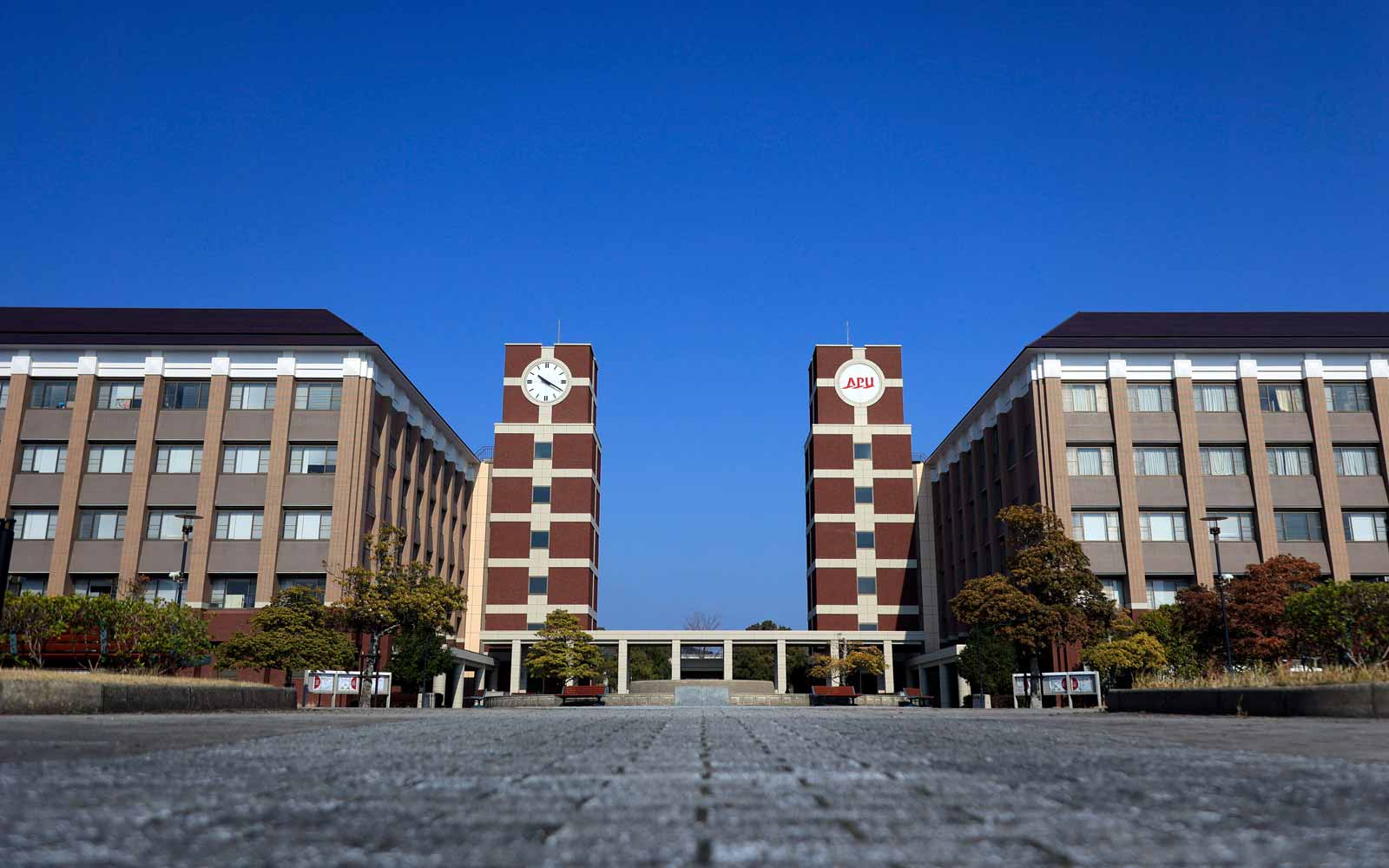 Symmetrical clock towers on the Ritsumeikan Asia Pacific University campus.