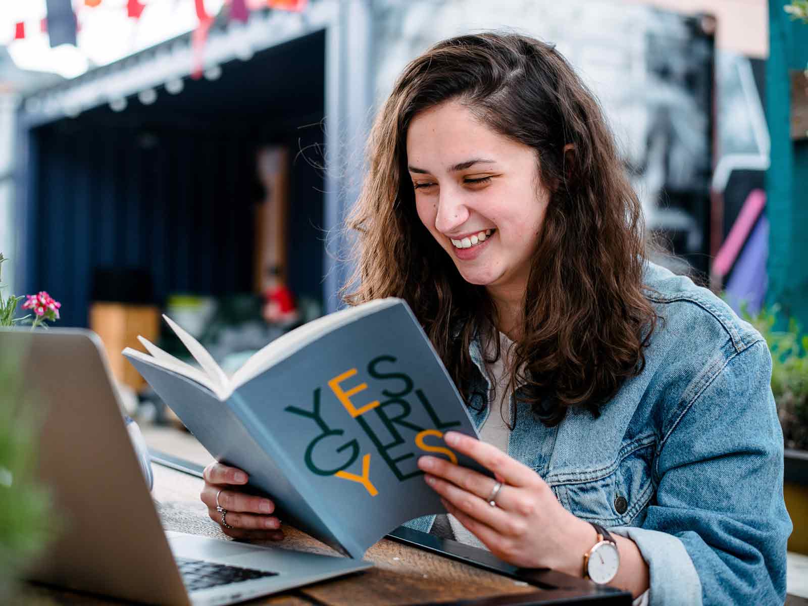 Student reading a book outside