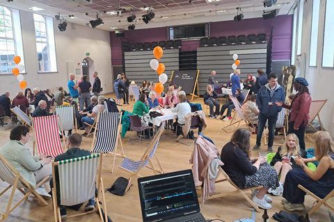 Alumni sitting on deckchairs in hall at Your YSJ Reunion 2023